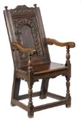 A James I carved oak open armchair:,