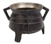 A 16th Century small bronze cauldron: with raised banded decoration and angular loop handles raised