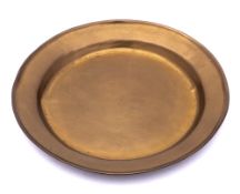 A 18th Century brass plate: of plain circular form, 24.5cm diameter.