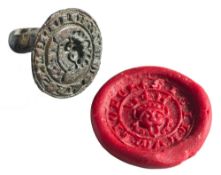 A Medieval bronze seal matrix: the face 'Sigillum Lionel' around a crowned mask,