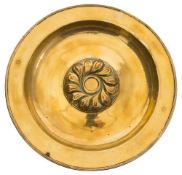 A large brass alms dish: with central floral boss, and triple reeded applied border,
