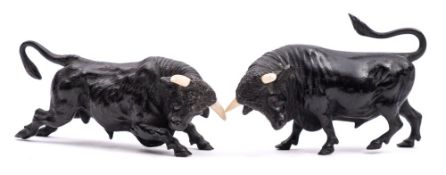A pair of late 19th Century Viennese cold painted bronze and ivory models of confronting bulls: