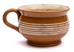 Two children's chamber pots: of traditional form one pottery example decorated with trailed bands