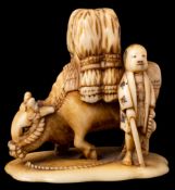 A Japanese carved ivory okimono: of a loaded buffalo and attendant, Meiji period, 3.5cm.