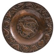 John Pearson, an embossed copper circular dish: the centre decorated with two stylised birds,