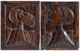 A pair of 16th Century carved oak 'Romayne' head portraits: the male facing sinister,