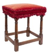A late 17th/early 18th Century oak stool:, with an upholstered stuff over seat in crimson velvet,