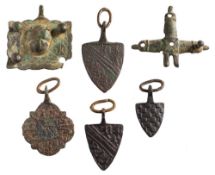Five late Medieval horse harness pendants: includes shield-shaped and cruciform examples (6).