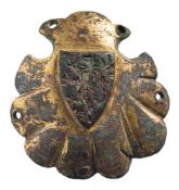 A late Medieval gilt metal horse harness pendant: shell-shaped with heraldic shield with lion