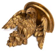 A late 18th/early 19th Century carved and gilt wall bracket: supported by an eagle with outspread