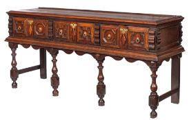 A 17th Century oak rectangular dresser base:, the top with a ledge back and moulded edge,