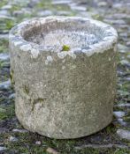 A drum-shaped sandstone mortar: 26cm (10 1/4in) diameter, 21cm (8 1/4in) high.