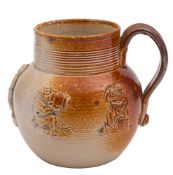 A small English saltglazed brown and grey stoneware mug: applied with sprigs of topers and a sailor,