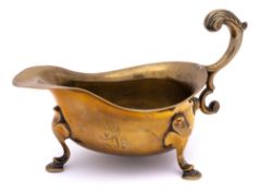 A mid 18th Century large brass sauceboat: crested,