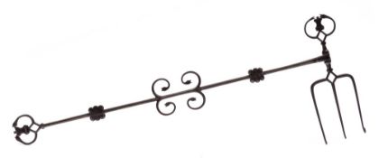 An early 19th Century wrought iron revolving toasting fork: the terminals worked with crowns and