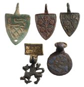 Five late Medieval horse harness pendants: includes three shield-shaped examples,