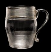 An English glass tankard: of barrel shaped form with strap handle decorated below the rim and above
