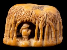 An unusual Japanese carved ivory netsuke: of a bamboo farmer inside a canopy of bamboo branches,