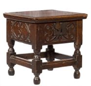 A 17th Century oak square box commode: with a hinged moulded top, the front,