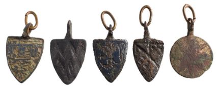 Five late Medieval horse harness pendants: includes four shield-shaped examples and a circular