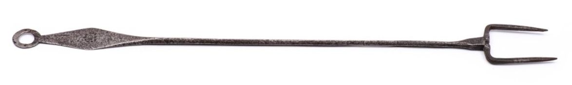 An 18th Century wrought iron flesh fork: with brass inlaid initials ID in a circle of pellets,