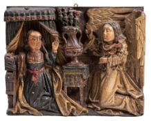 A late 15th Century oak and polychrome carved panel, The Annuciation: possibly North West Europe,