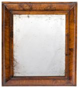 An early 18th Century walnut cushion framed mirror:, with original rectangular bevelled plate,