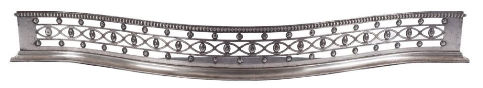 A late 18th Century steel fender: of serpentine form with pierced and applied patrae decoration,
