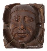 A late 15th/early 16th Century carved oak corner boss or corbel: of a tonsured monk's head, 25.