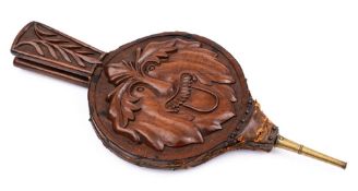 A pair of 19th Century walnut bellows: each side carved with the bust of the Green Man,