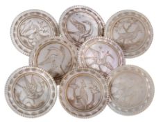 A set of eight large 19th century mother of pearl buttons: engraved with birds in landscapes within