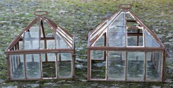 Two cast iron and part glazed garden cloches: with detachable pitched roofs,