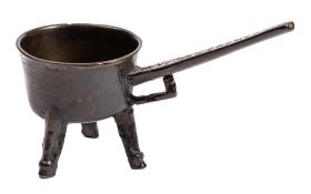 A very small mid 17th Century bronze skillet: on tapering legs with hoof feet,
