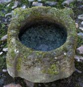 A Medieval stone mortar: of circular form, with four buttresses, 37cm (1ft 2 1/2in).