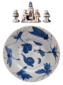 An Arita porcelain dish and group of miniature toys: the former painted in blue with insects,