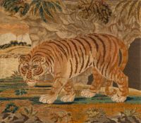 A large Regency silk and woolwork picture of a tiger: walking with head lowered across a landscape,