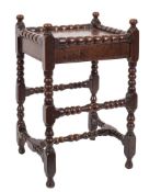 A Charles II oak bobbin turned occasional table: having turned finials fitted with a replaced