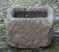 A stone trough: of irregular oblong shape - possibly Heavitree stone,