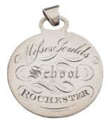A circular silver school badge of merit: for 'Misses Gould's School, Rochester',