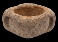 A Medieval limestone mortar: of circular outline with four buttresses, 32cm. wide.