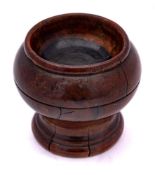 An 18th Century pearwood salt: of circular outline with ring turned decoration, 5cm high.