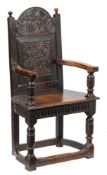 A late 16th Century carved oak caqueteuse armchair:,