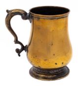An 18th Century brass tankard: of baluster form, with acanthus capped scroll handle,