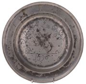 A late 18th Century pewter dish: with engraved whimsical scene and dated 1796,