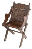 A rare Elizabeth I oak Glastonbury armchair:, of pegged construction,
