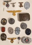 A group of German military badges and cap badges:, including a wound badge, a Minesweeper stick pin,