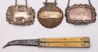 A folding champagne knife by E Mercer and Co together with three silver bottle labels:,
