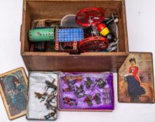 A small group of diecast soldiers and cowboys together with a quantity of Meccano in a brass bound