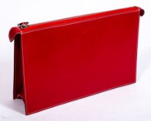 A red leather handbag by Ferrari:, with embossed prancing horse and white stitched border,
