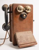 Two Ericsson N2516T mahogany cased wall mounted telephones:, with black bakelite handset,